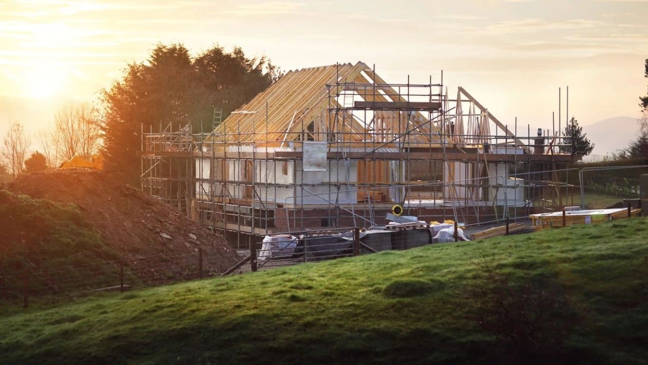 A house under construction with scaffolding around it.