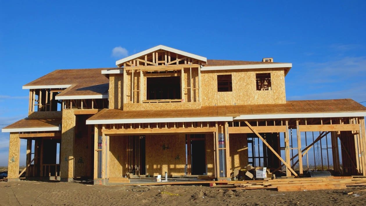 A house under construction with some windows being built.